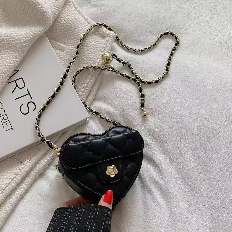 Amorette black quilted heart crossbody bag, close-up