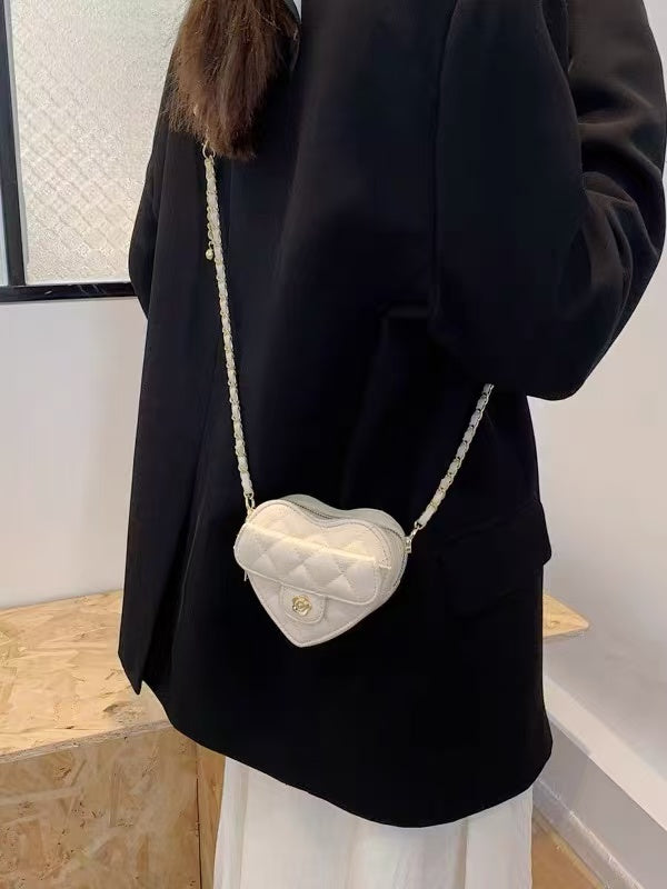 Amorette ivory heart mini bag worn with a casual outfit