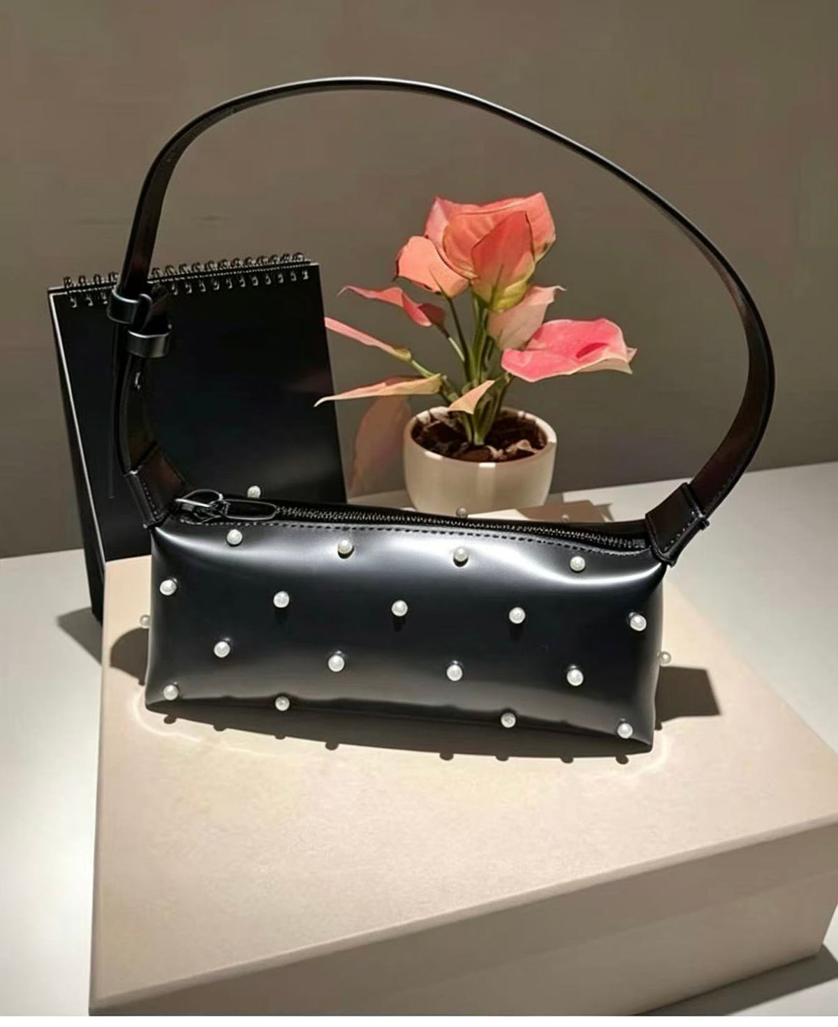 Amoirelle Lunette glossy black shoulder bag with pearl-like bead accents